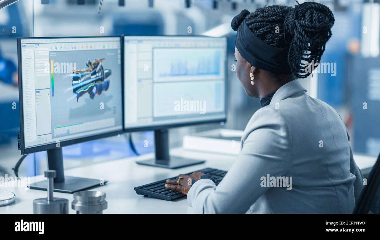 Beautiful Female Engineer Working on Personal Computer in the High-Tech ...