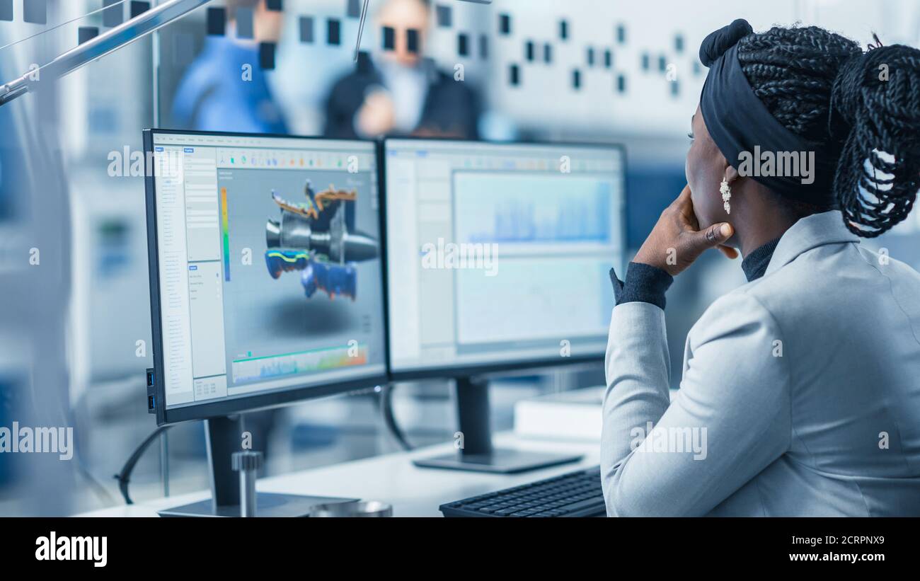 Beautiful Female Engineer Working on Personal Computer in the High-Tech ...