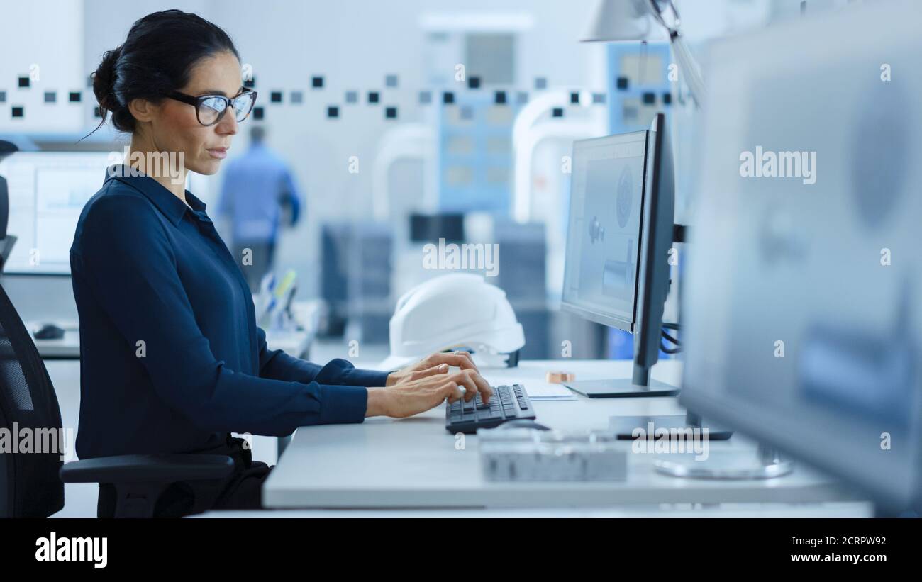 Beautiful Female Engineer Working on Personal Computer in the High-Tech ...