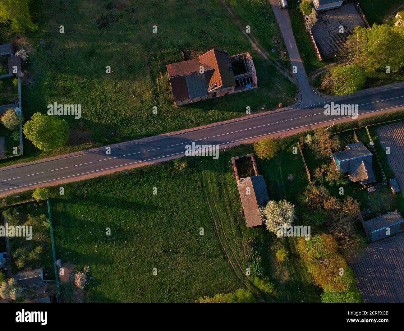 Eagle eyeshot of rural houses with the green fields around Stock Photo