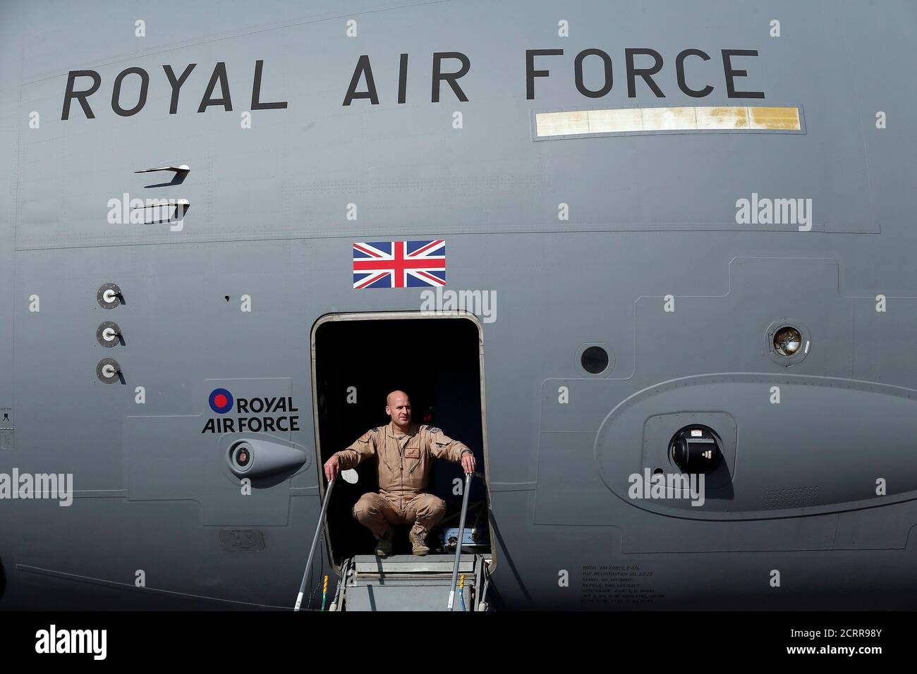 A British soldier looks out from a Royal Airforce  C-17 Globemaster III aircraft at a Kandahar airfield, Afghanistan December 20, 2012. REUTERS/Stefan Wermuth (AFGHANISTAN - Tags: TRANSPORT MILITARY CONFLICT) Stock Photo