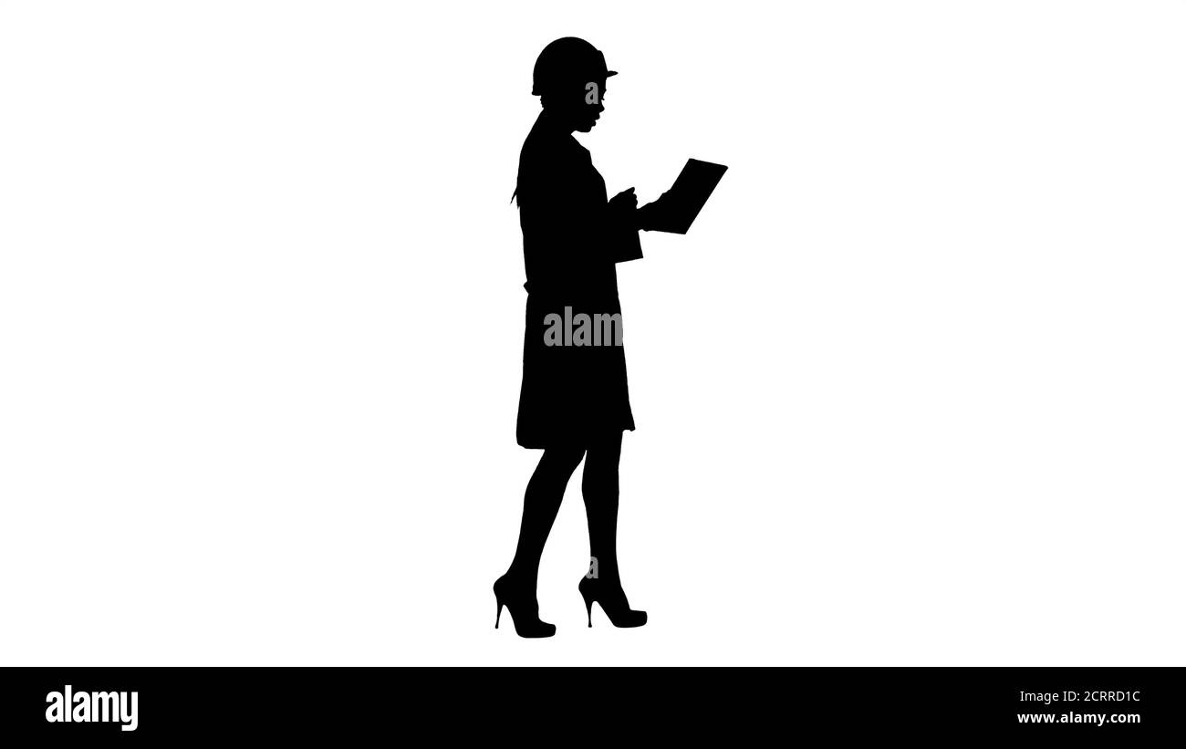 Silhouette Woman engineer with tablet making video call. Stock Photo