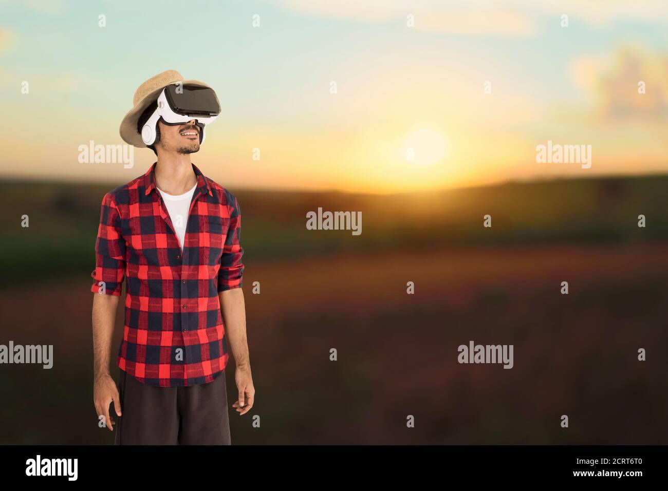 Farmer at sunset outdoor . Man with hat in a sunset blurry background. Space for text. Stock Photo