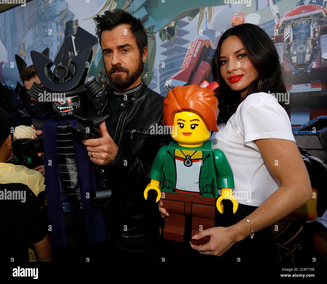 Cast members Olivia Munn and Justin Theroux hold their respective characters of Koko and Garmadon at an event for "The LEGO Movie" during 2017 Comic-Con Convention in Diego,