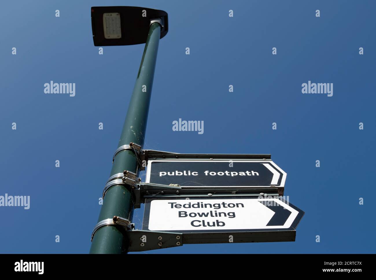 lamppost with right pointing signs for a public footpath and teddington bowling club, teddington, middlesex, england Stock Photo