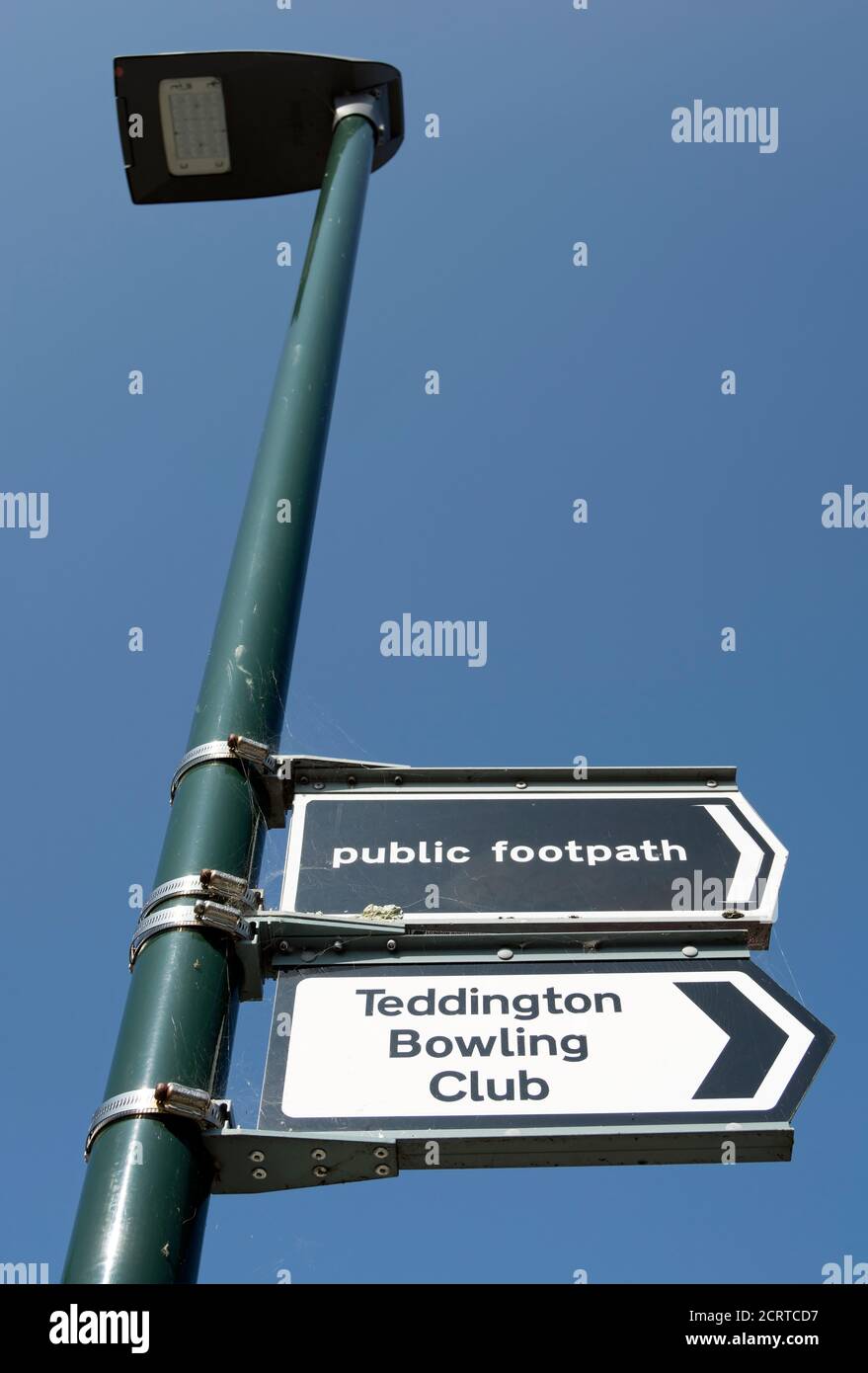 lamppost with right pointing signs for a public footpath and teddington bowling club, teddington, middlesex, england Stock Photo