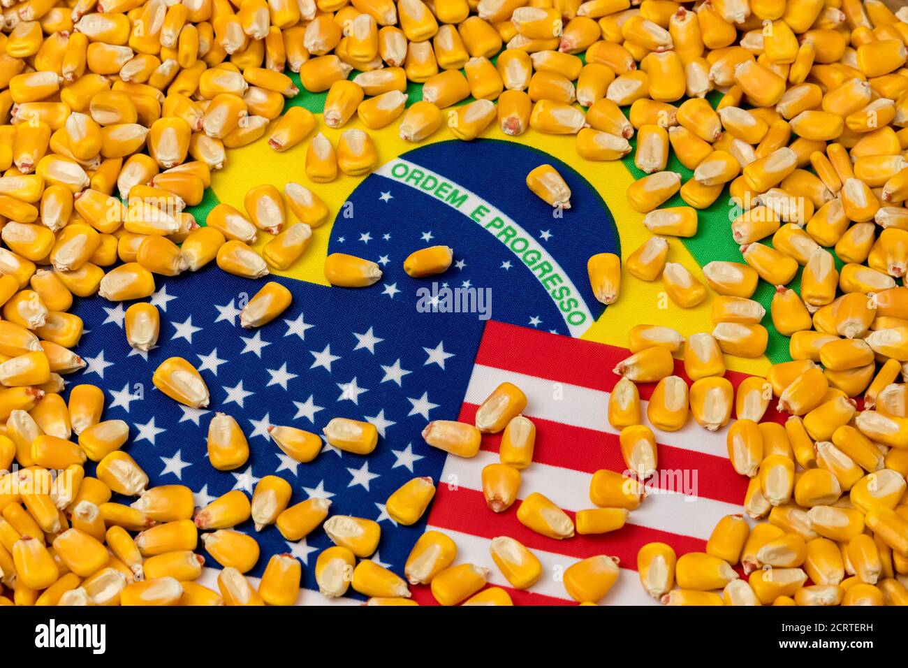 Flags of United States of America and Brazil covered in corn kernels. Concept of American and Brazilian agriculture imports, exports, trade war, agree Stock Photo