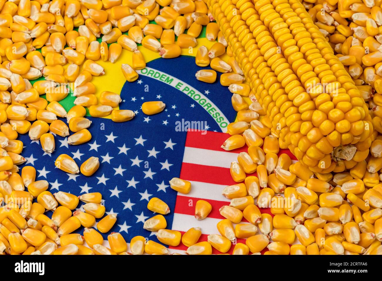 Flags of United States of America and Brazil covered in corn kernels. Concept of American and Brazilian agriculture imports, exports, trade war, agree Stock Photo