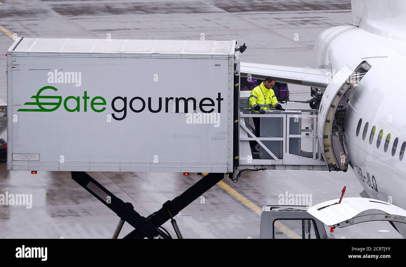 Gate Gourmet Staff Part Of Swiss Airline Catering Firm Gategroup Holdings Loads A Trolley Aboard An