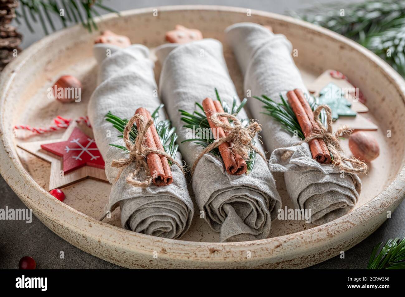 Handmade Christmas table setting with napkin and gingerbread cookies on wooden table Stock Photo