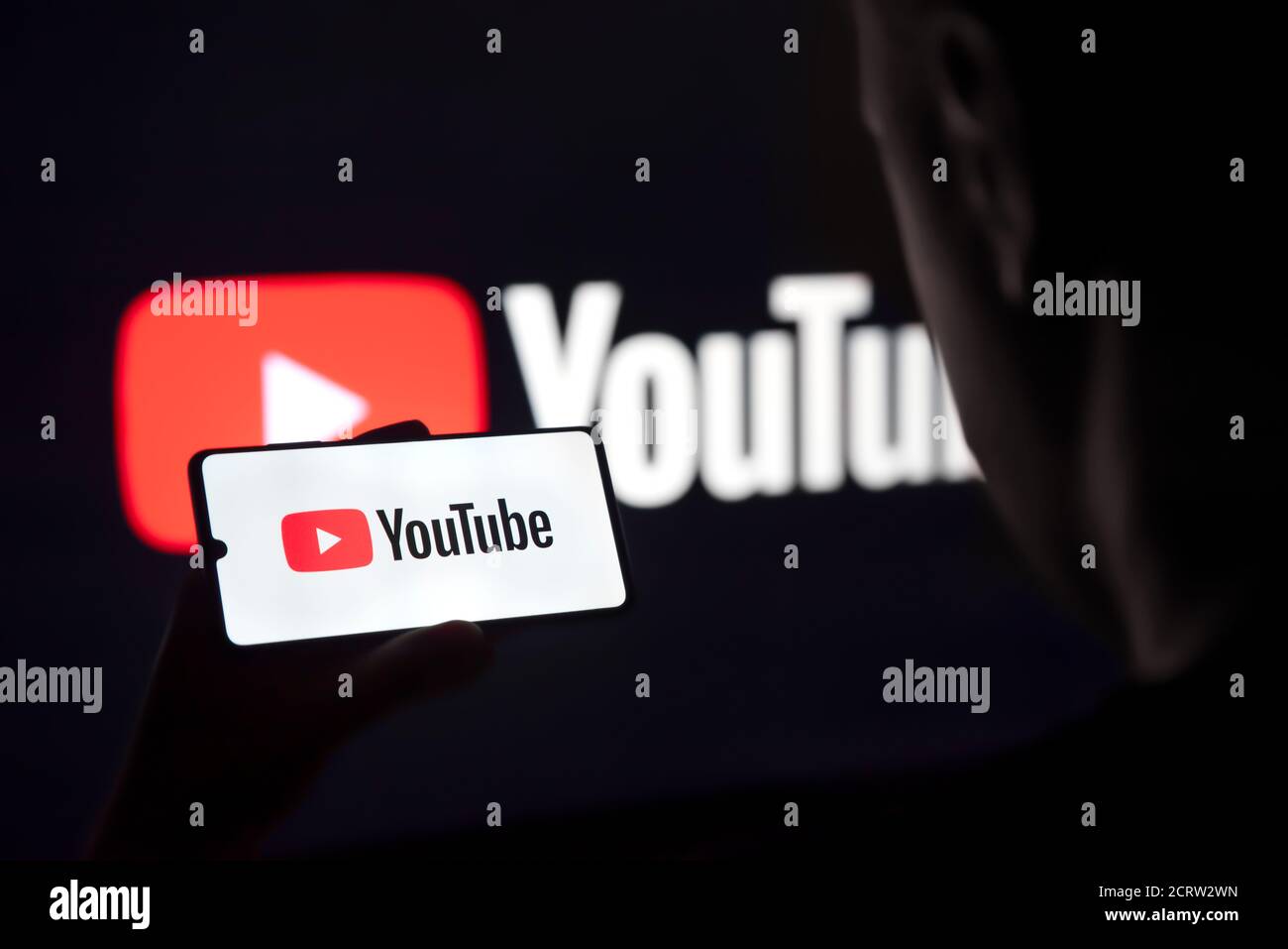 Wroclaw, Poland - SEP 16, 2020: Man holding smart phone with YouTube logo on screen. YouTube is most popular video service developed by Google. Stock Photo