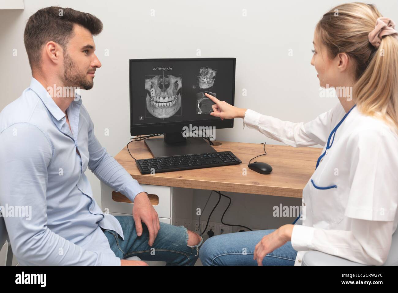 Computer diagnostics dental tomography. Dentist shows the patient an x