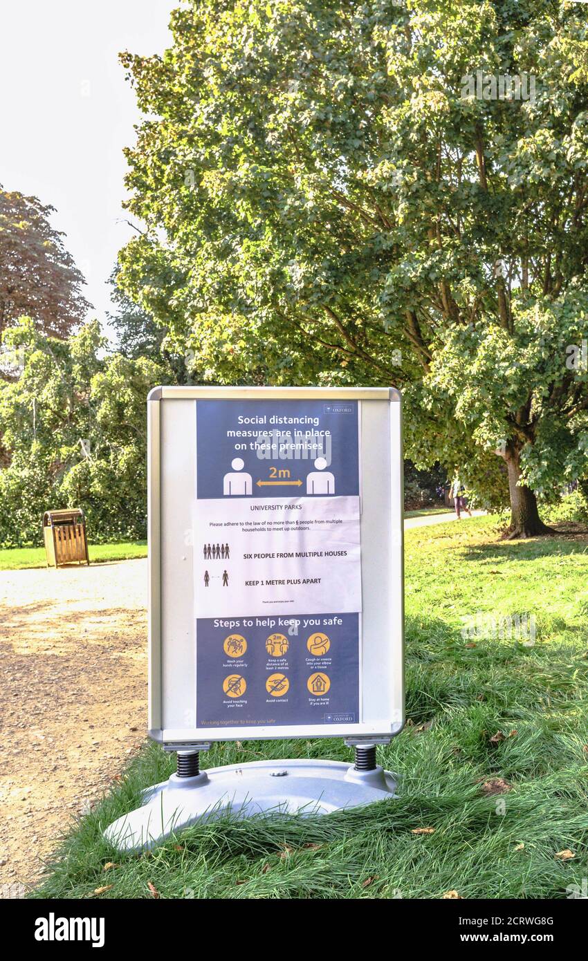 Social distancing rules and public health advice displayed in Oxford University Parks, Oxford, UK Stock Photo