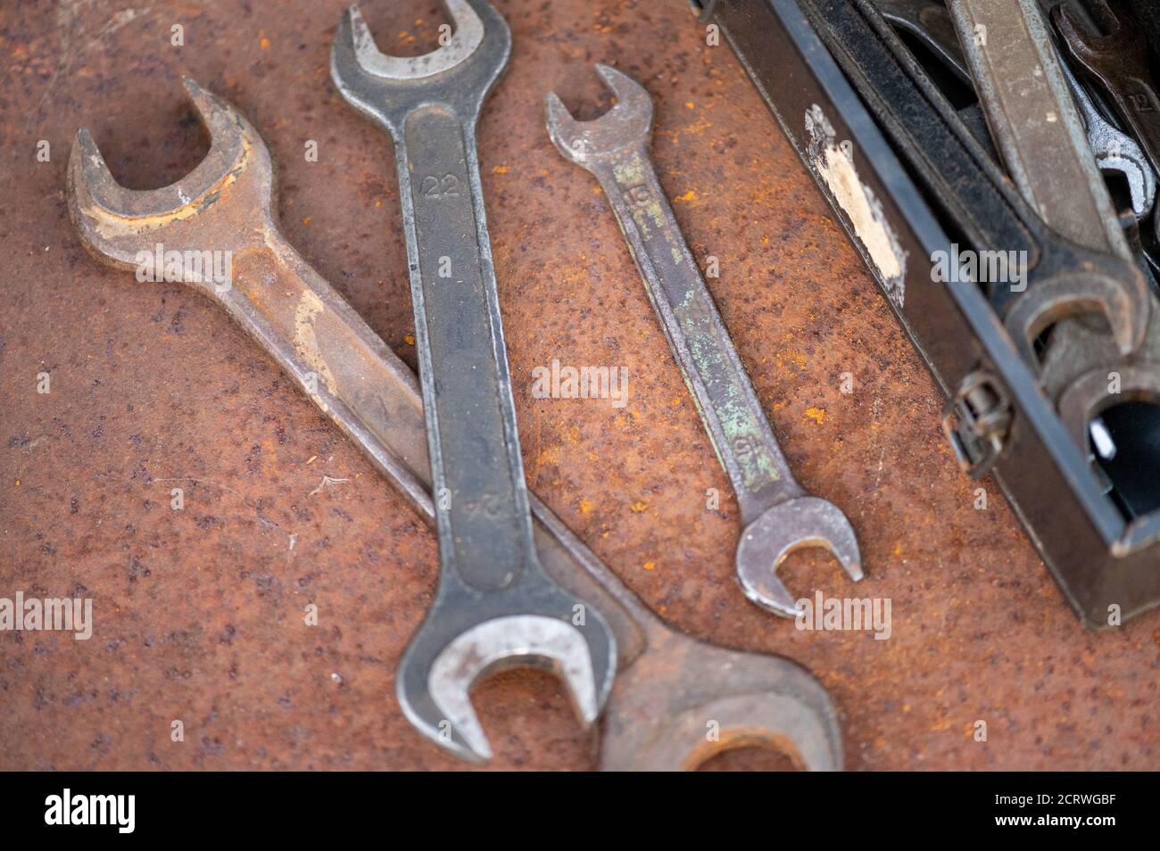 Old wrenches on a rusty sheet of metal, close-up, selective focus Stock Photo