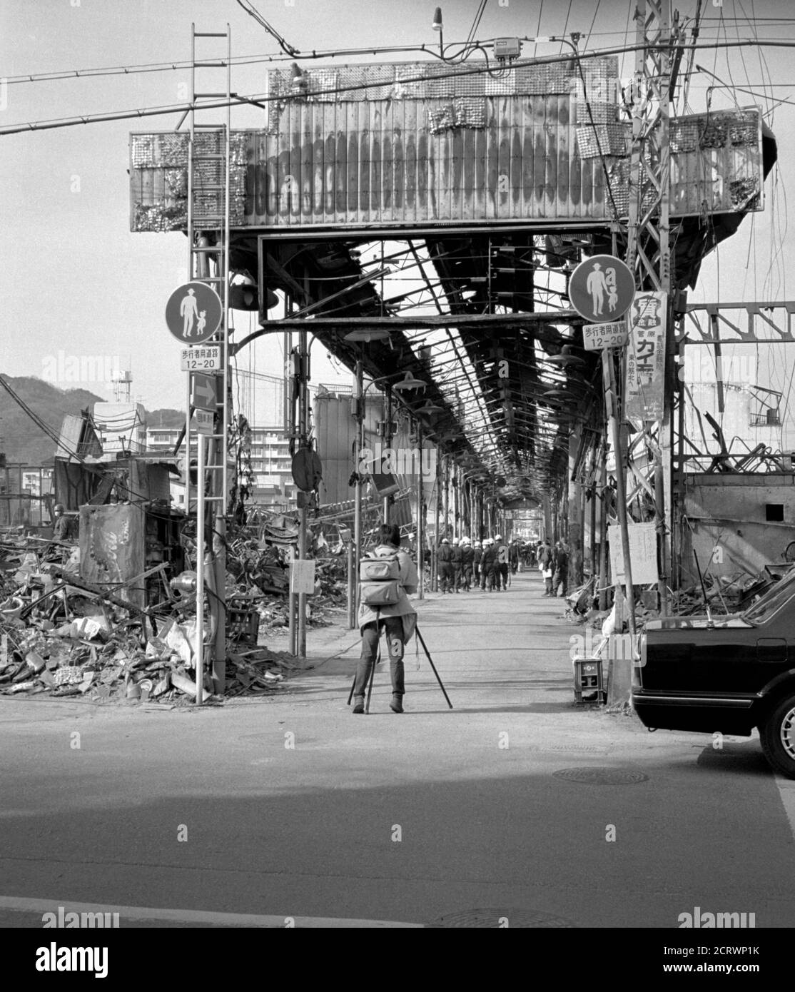 Man takes photo of arcade downtown ruins in the aftermath of the 1995 Great Hanshin Earthquake in Kobe, Japan Stock Photo