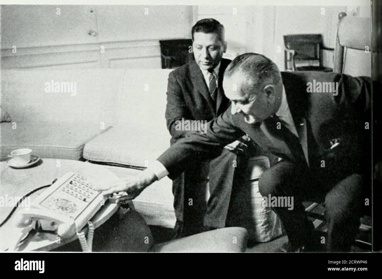 . Bell telephone magazine . ll suppa battery of phones for on-the-spot rj between Washington and Moscow, wainstalled. It was then, too, that telt,phones sounded throughout the capitfiwith an almost incessant ringing of bell:There is a story, possibly apocryphathat the White House switchboard w:iso heavily used by the New Front i(n-:^men that it practically blew a fuse :ileast three times. The telephone has continued to hevital instrument of command in the administration of President Lyndon EJohnson, whose personal use of iihcinehas been mentioned so often in the jnesthat it is already legendar Stock Photo