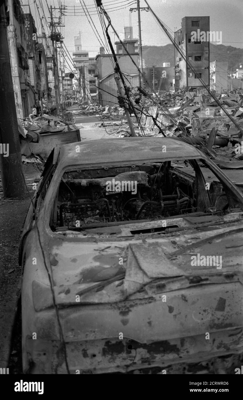 Ruins of a completely burned car among the aftermath of the damage caused from the 1995 Great Hanshin Earthquake in Kobe, Japan Stock Photo