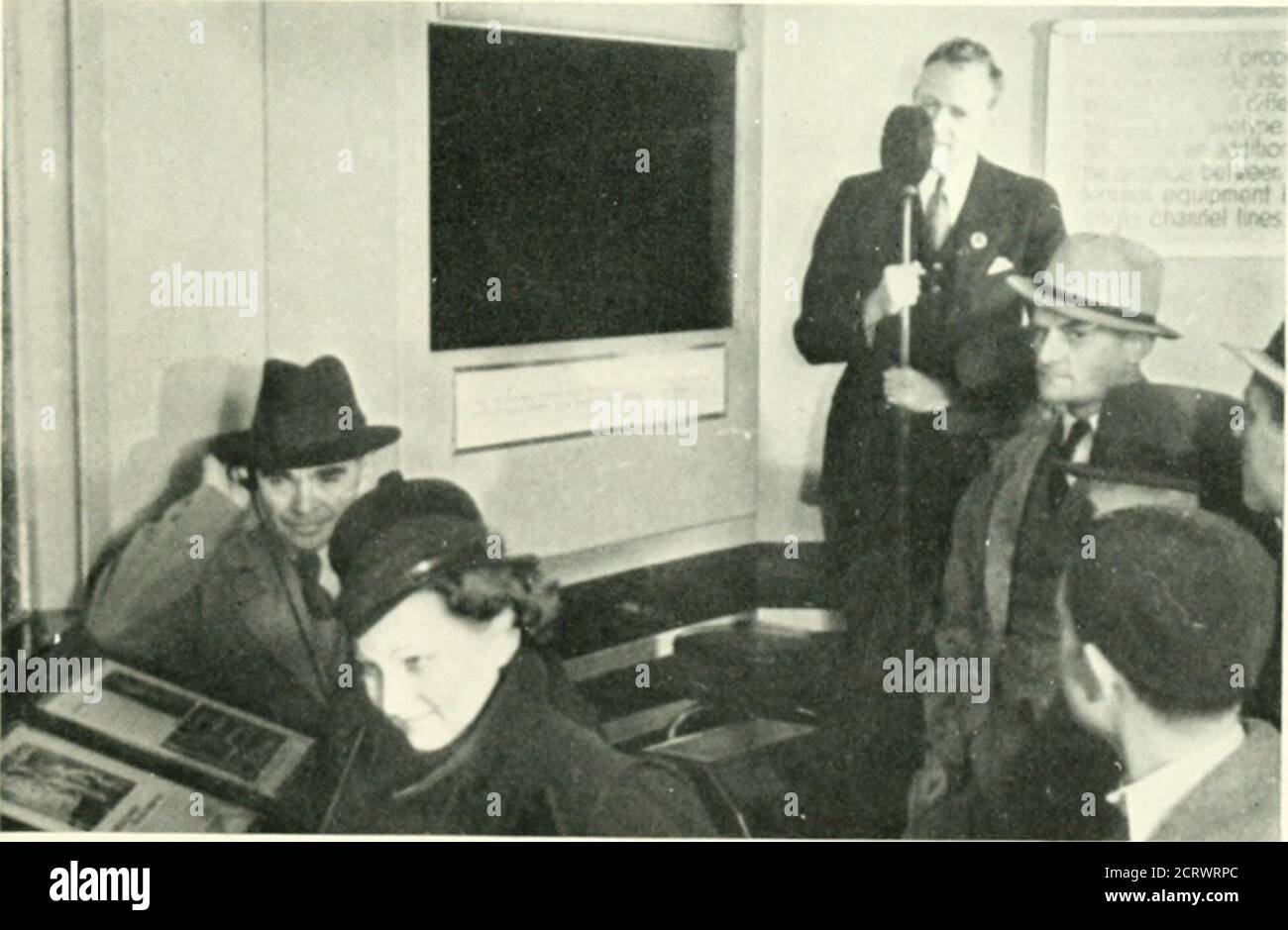 . Bell telephone magazine . FiGiR£ 9. A Visitor Speaks into the Speech Scramhllk.. FiGiRE 10. Inside the Mieti-iiiannel Demonstration. Stock Photo