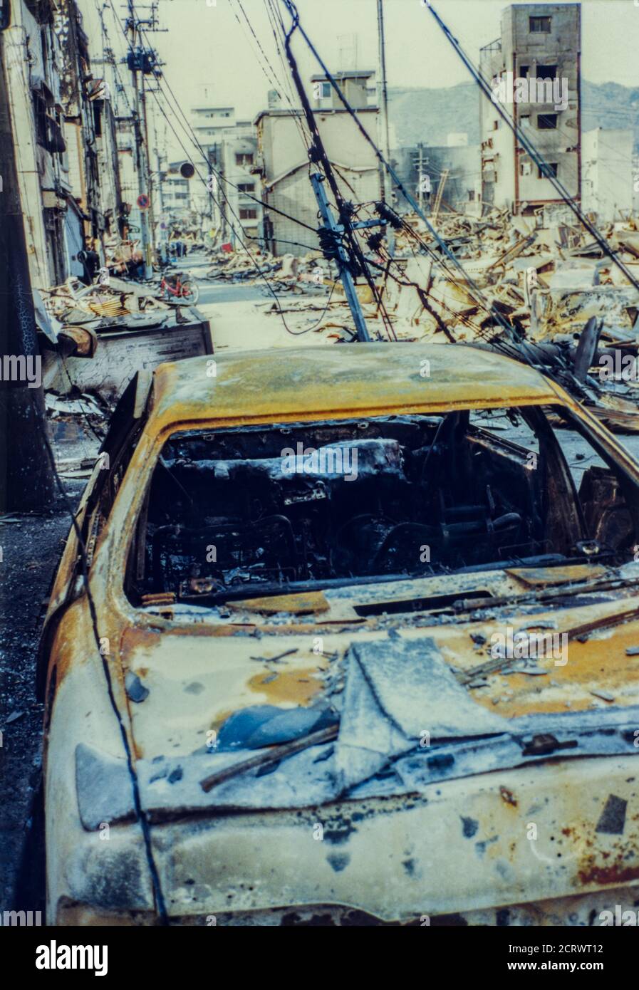 Ruins of a completely burned car among the aftermath of the damage caused from the 1995 Great Hanshin Earthquake in Kobe, Japan Stock Photo