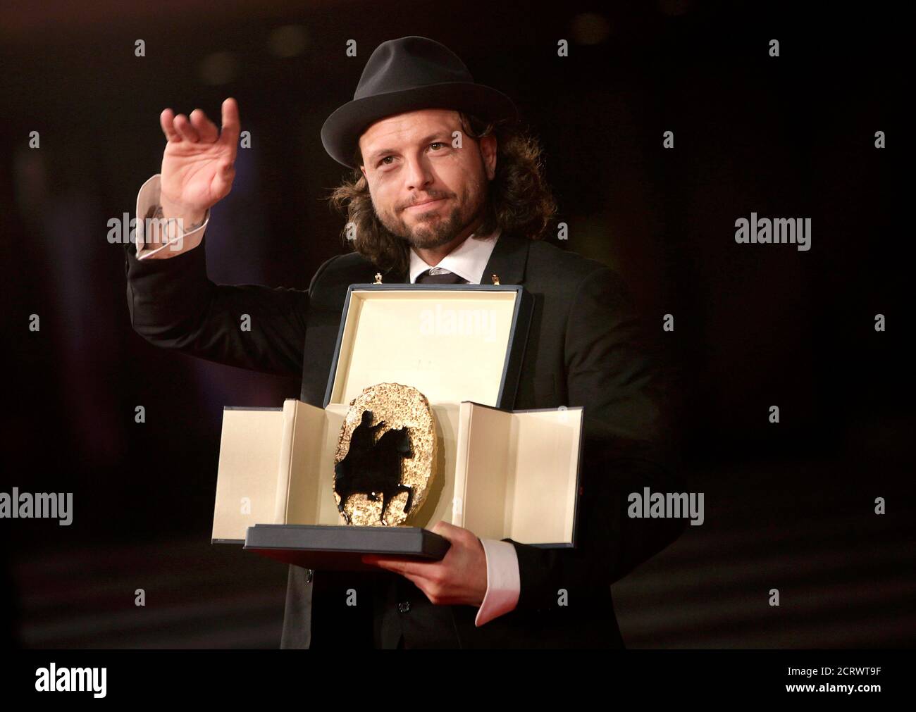 Danish director Nicolo Donato poses with his award on the red carpet at the Rome Film Festival October 23, 2009. Donato received the Golden Marc'Aurelio jury award for best film 'Brotherhood'. REUTERS/Tony Gentile  (ITALY ENTERTAINMENT) Stock Photo