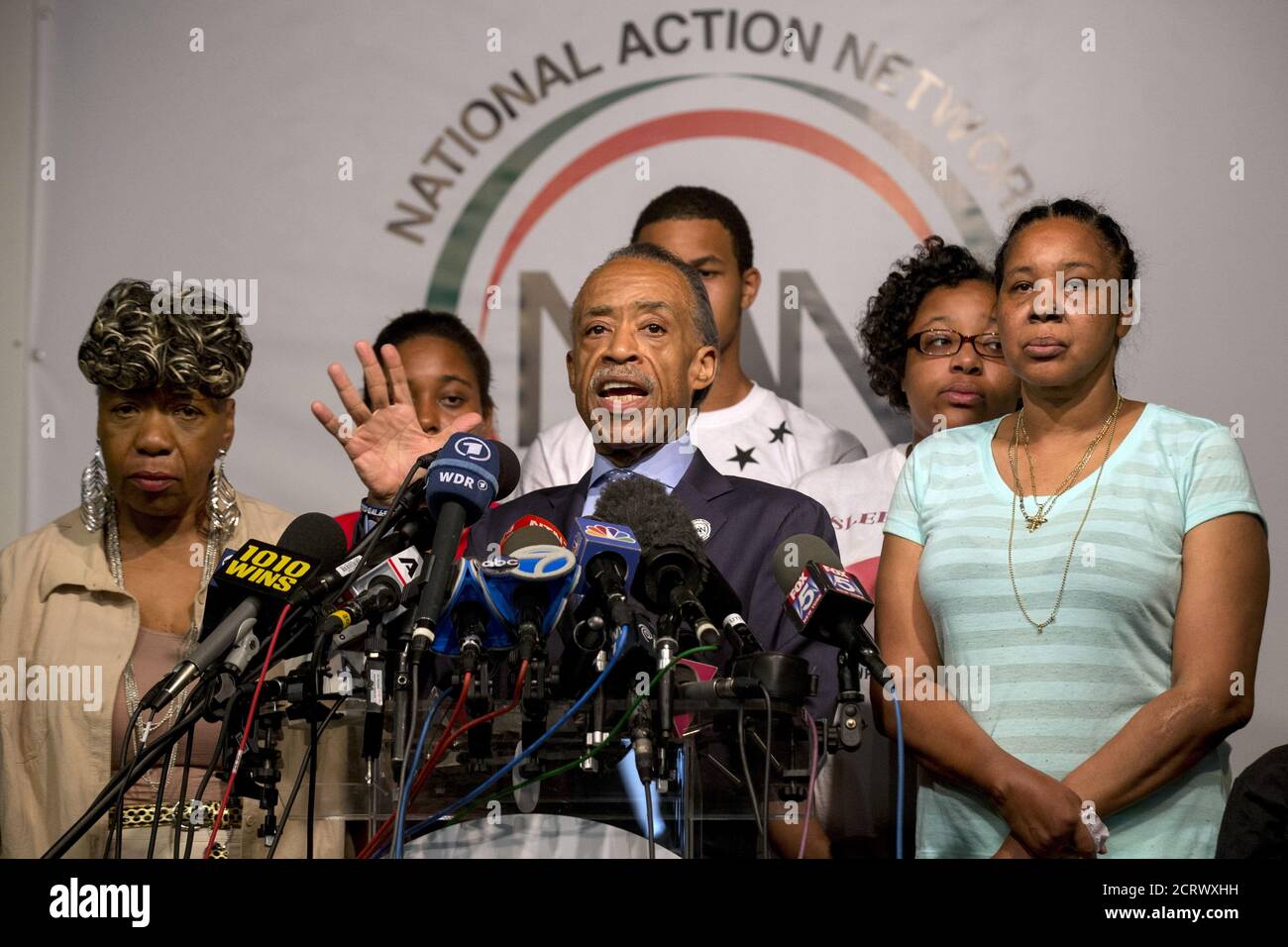 Rev. Al Sharpton (C) speaks with the family of Eric Garner during a news conference at the National Action Network in New York July 14, 2015. One day after settling a $5.9 million wrongful death case with New York City, the family of Eric Garner renewed calls to criminally charge the police officer who put him in a fatal chokehold last July. REUTERS/Brendan McDermid Stock Photo