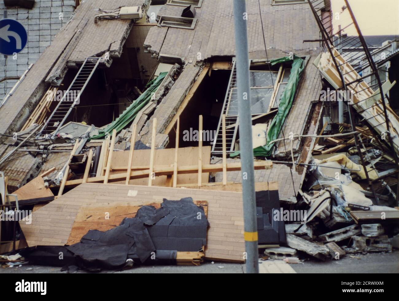 Apartment complex collapsed on its side damaged from the 1995 Great Hanshin Earthquake in Kobe, Japan Stock Photo