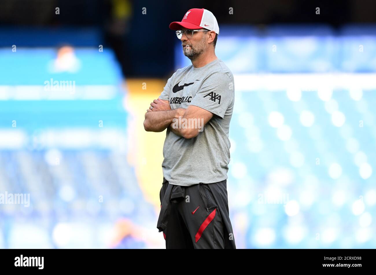 Liverpool manager Jurgen Klopp watches on during the warm up before the Premier League match at Stamford Bridge, London. Stock Photo