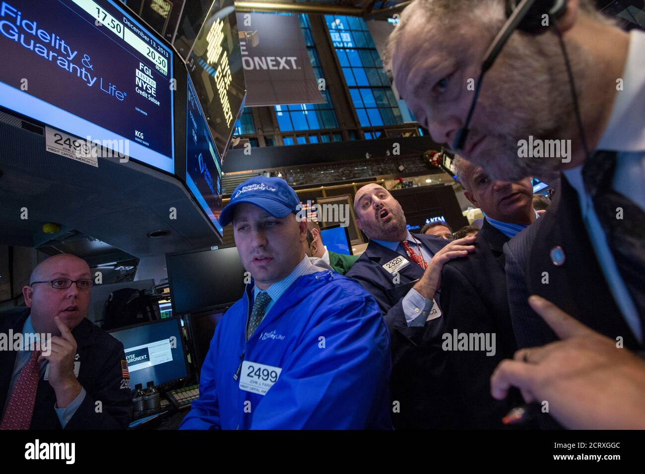 Traders work on the IPO for Fidelity & Guaranty Life on the floor of the New York Stock Exchange December 13, 2013. Shares of the insurer, controlled by billionaire Philip Falcone's Harbinger Group Inc, rose as much as 12 percent in their market debut, valuing the company at about $1.07 billion.REUTERS/Brendan McDermid (UNITED STATES - Tags: BUSINESS) Stock Photo