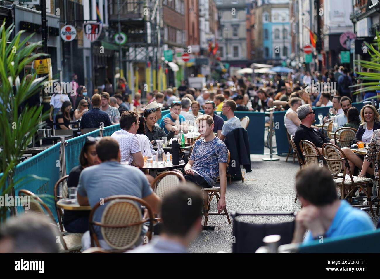 People sit at tables outside restaurants in Soho, amid the coronavirus disease (COVID-20) outbreak, in London, Britain, September 20, 2020. REUTERS/Henry Nicholls Stock Photo