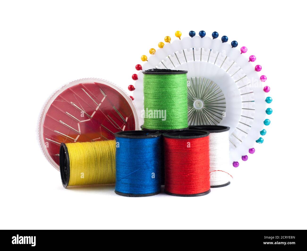 Composition with tailor needles and threads over white background Stock Photo