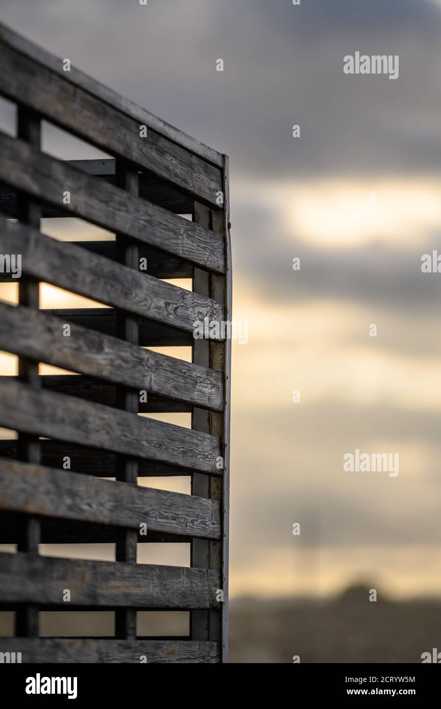 wooden fence with defocused sunrise sky in the background Stock Photo