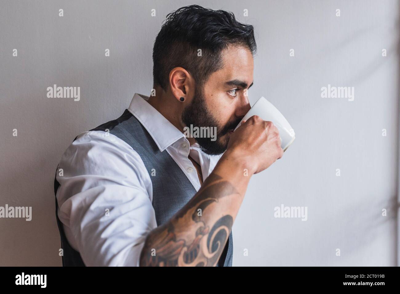 Handsome man dressed as executive  drinking coffee Stock Photo