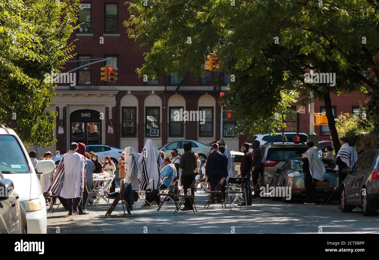 worshipers gather in a street of New York for an outdoor Rosh Hashana service during the coronavirus or covid-19 pandemic Stock Photo