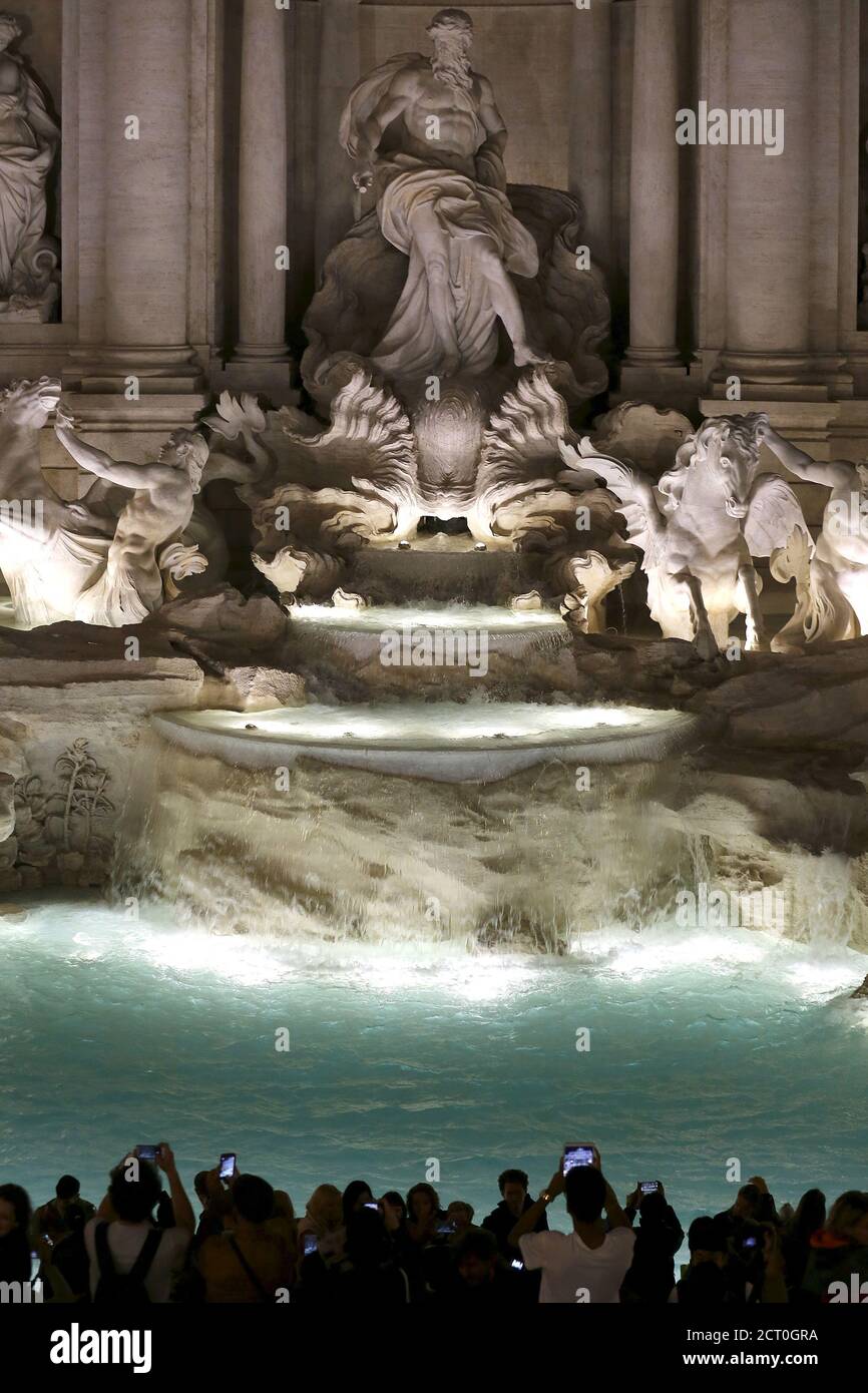 People take pictures during the opening ceremony of Rome's Trevi
