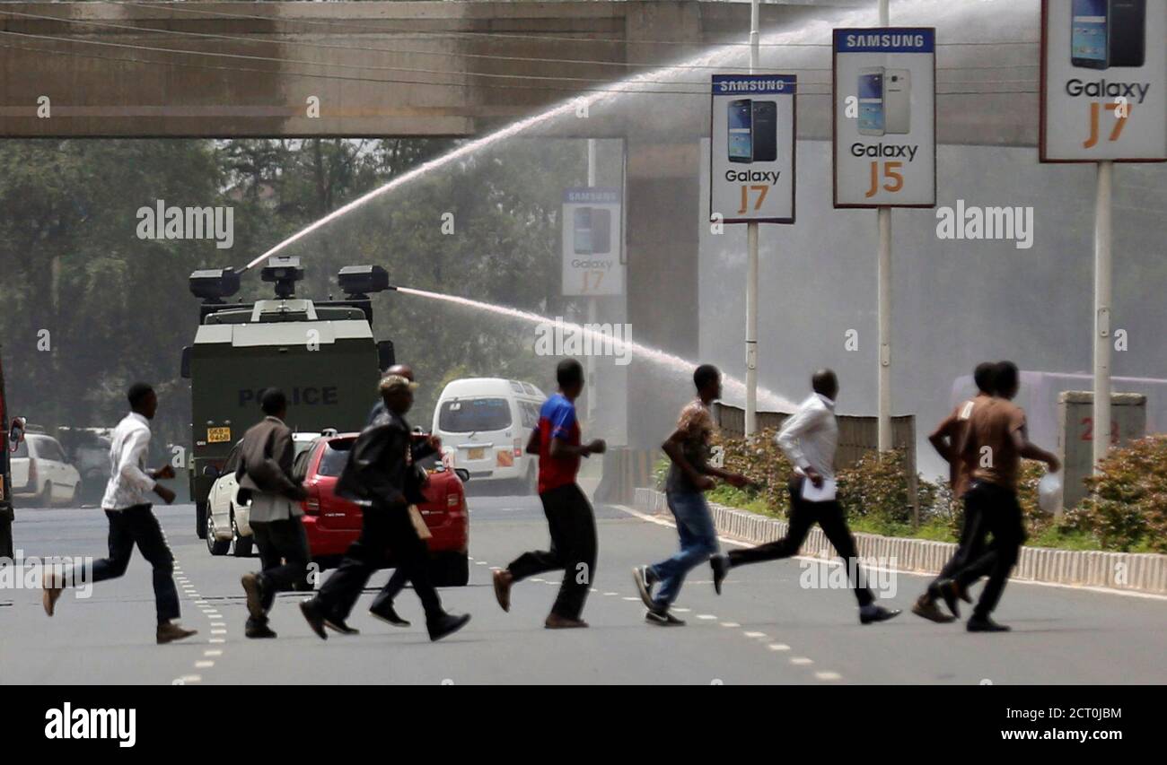 Riot police use a water-cannon to disperse supporters of Kenya's opposition Coalition for Reforms and Democracy (CORD) during a protest at the premises hosting the headquarters of Independent Electoral and Boundaries Commission (IEBC) to demand the disbandment of the electoral body ahead of next year's election in Nairobi, Kenya, May 23, 2016. REUTERS/Thomas Mukoya     TPX IMAGES OF THE DAY Stock Photo