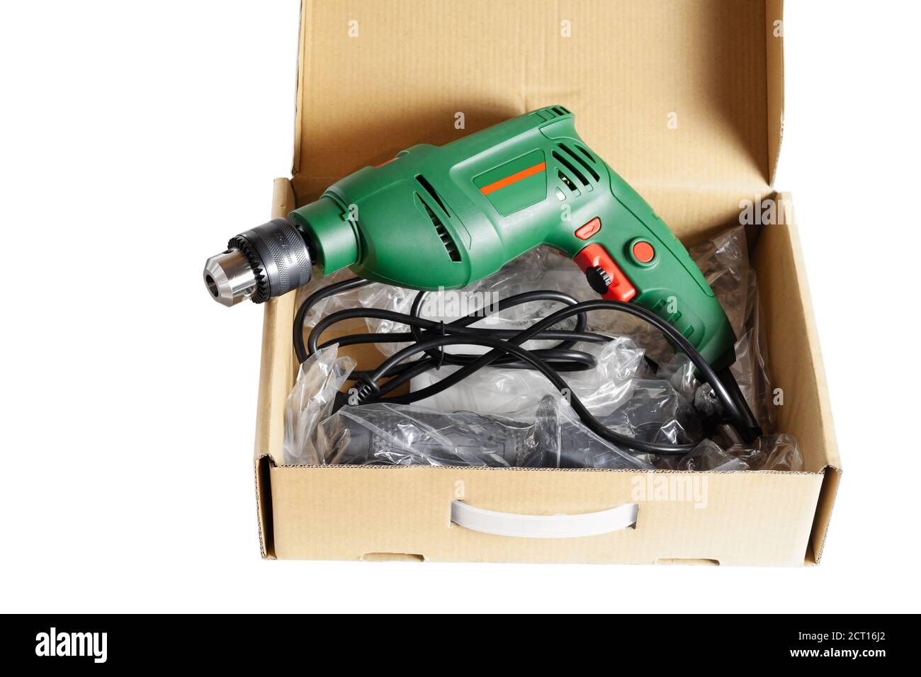 New electric drill in a cardboard box. Closeup. Isolated over white