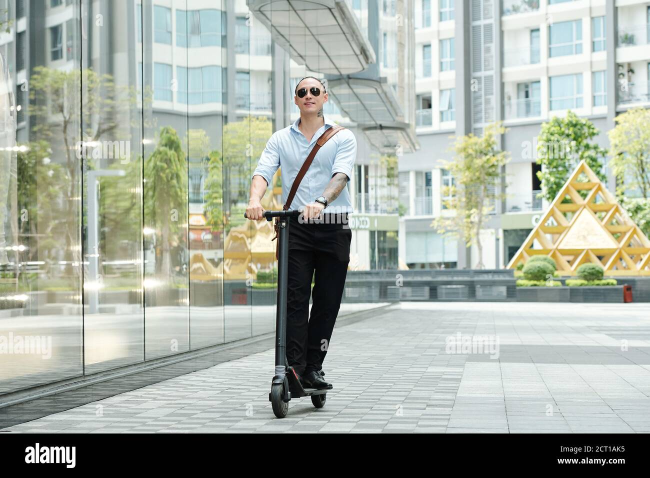 Man enjoying riding on scooter Stock Photo