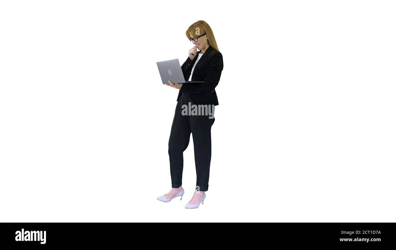 Business woman working on laptop smiling on white background. Stock Photo