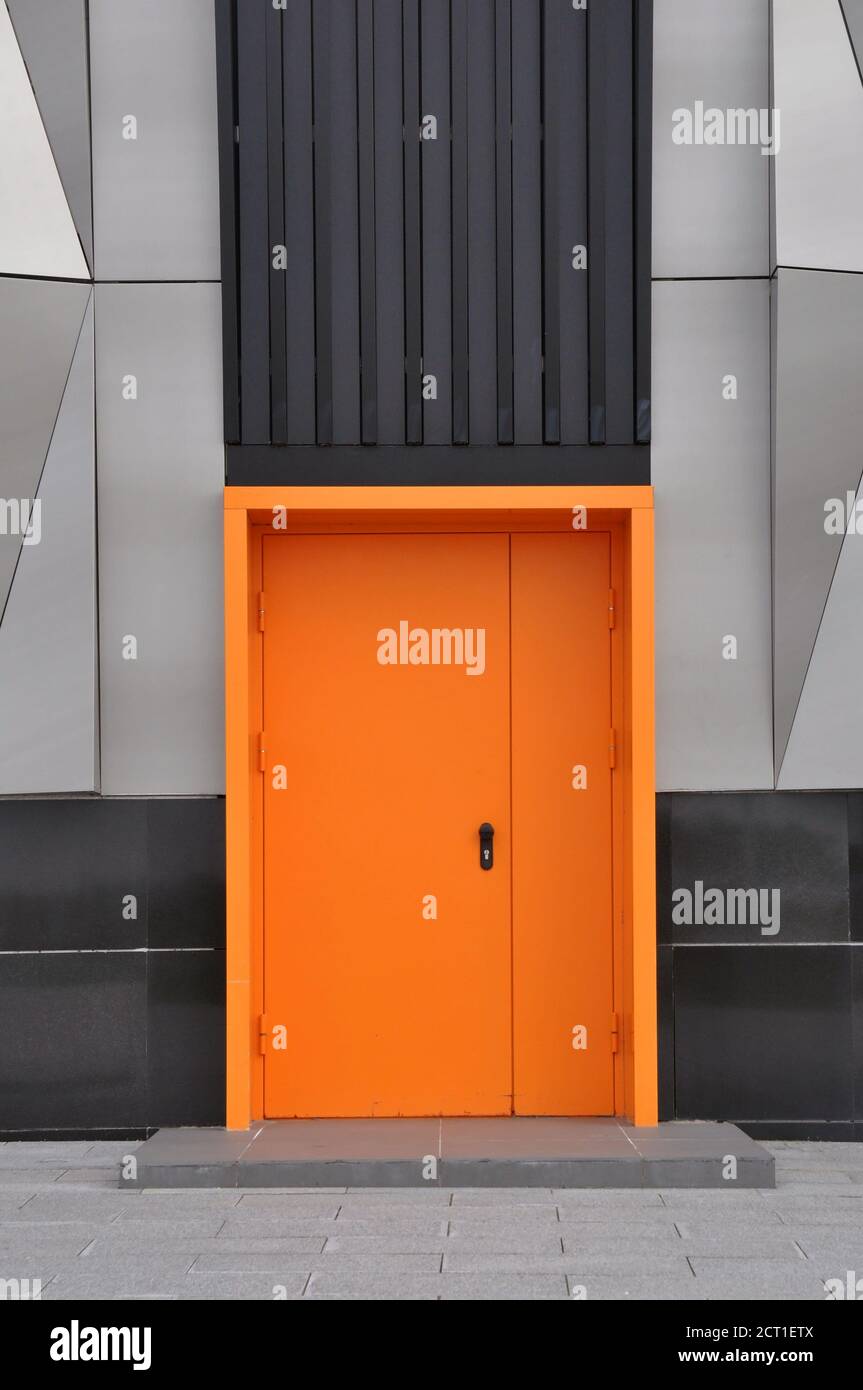 closed metal fire door in orange color. Stock Photo