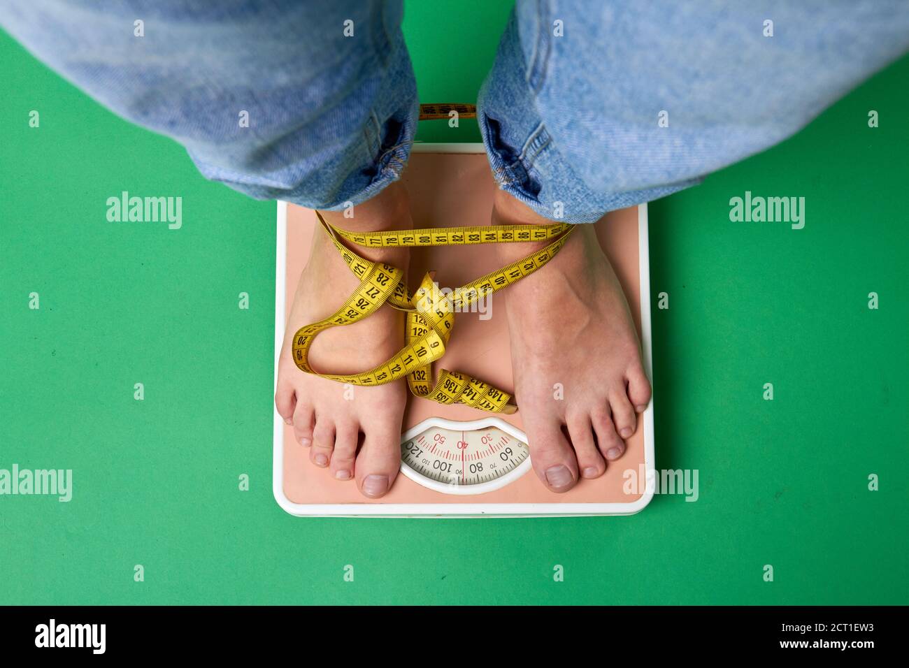 Top view wrapped with tape feet standing on scales. Stock Photo