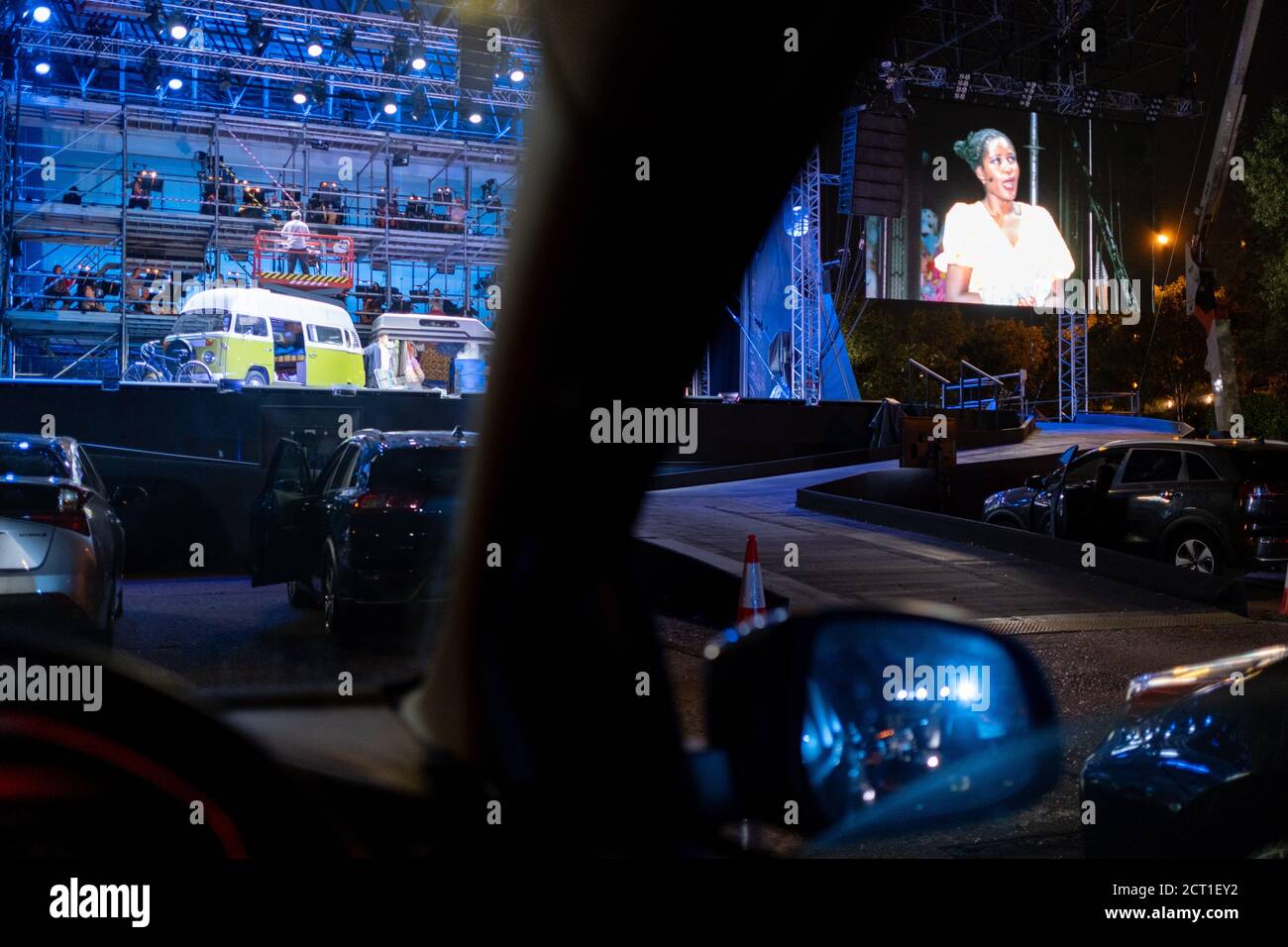 Seen from the driver's seat, British Soprano Nardus Williams plays Mimi in Puccini's La bohème, performed by English National Opera (ENO) as a drive-in (ENO Drive and Live) at Alexandra Palace, on 18th September 2020, in London, England. This is ENO's first public performance since the closure of their West End Colisseum home venue, because of the Coronavirus pandemic lockdown in March. This is Europe's first live drive-in opera production that audiences can safely experience from their cars and ENO's first public performance since the closure of their West End Colisseum home venue, because of Stock Photo