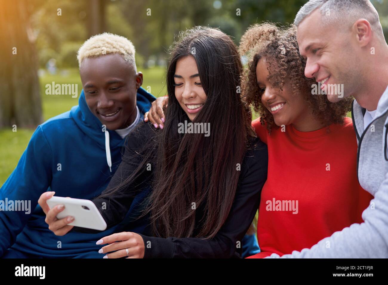 Multi ethnic friends outdoor taking a selfie on smartphone. Diverse ...