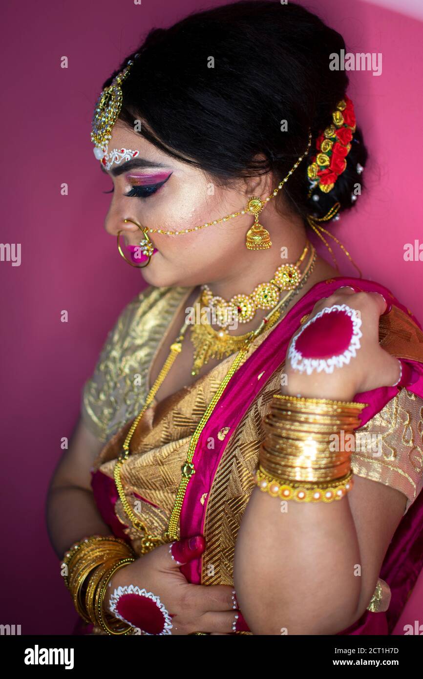 bridal portrait of indian lady wearing traditional saree and gold jewellery Stock Photo