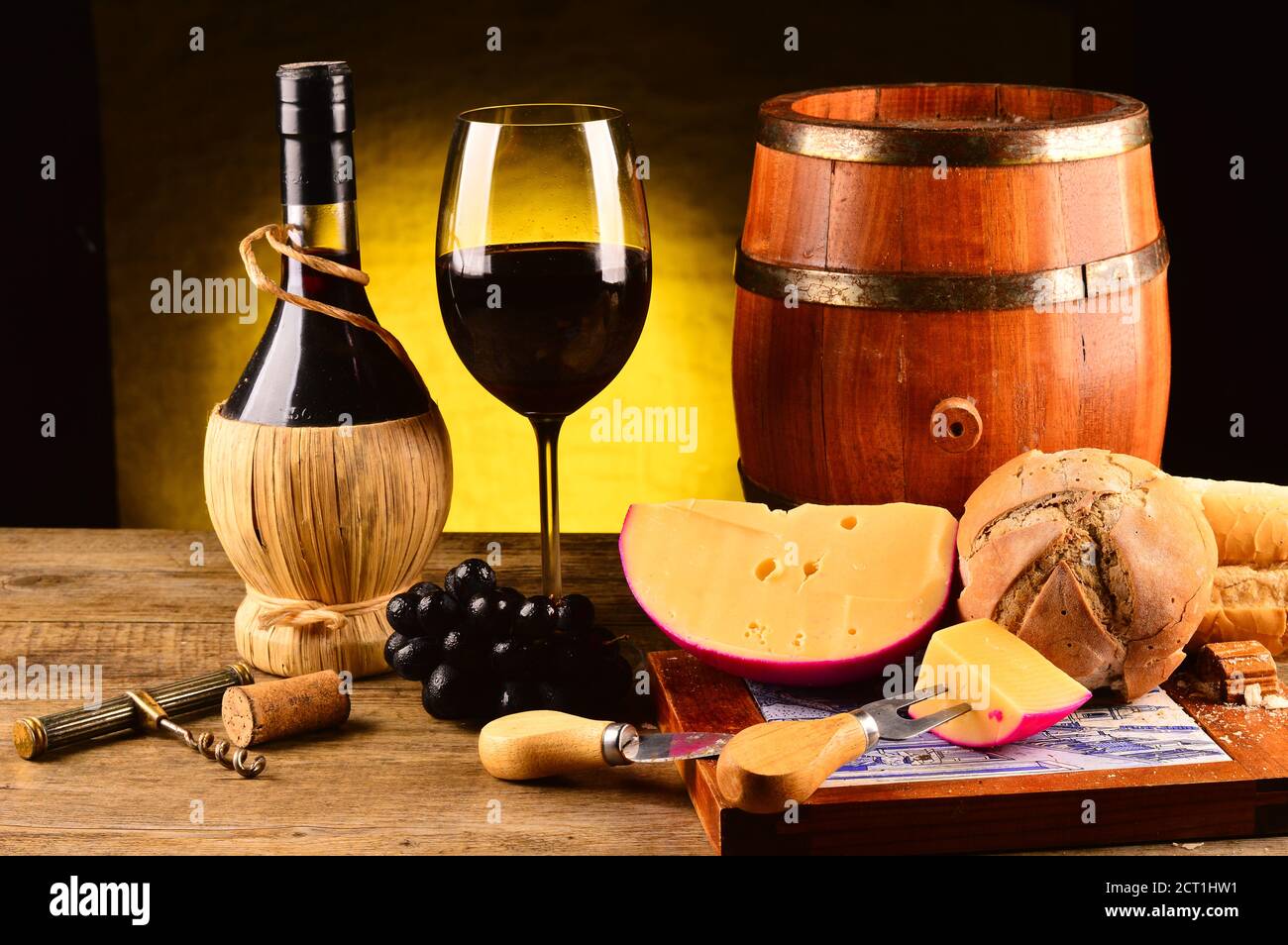 Glass of red wine with cheese, bread and a wooden barrel nearby Stock ...