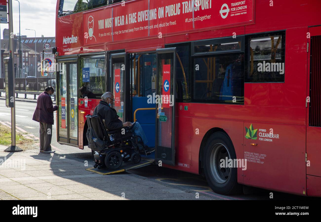 Wheelchair enters public bus service hires stock photography and