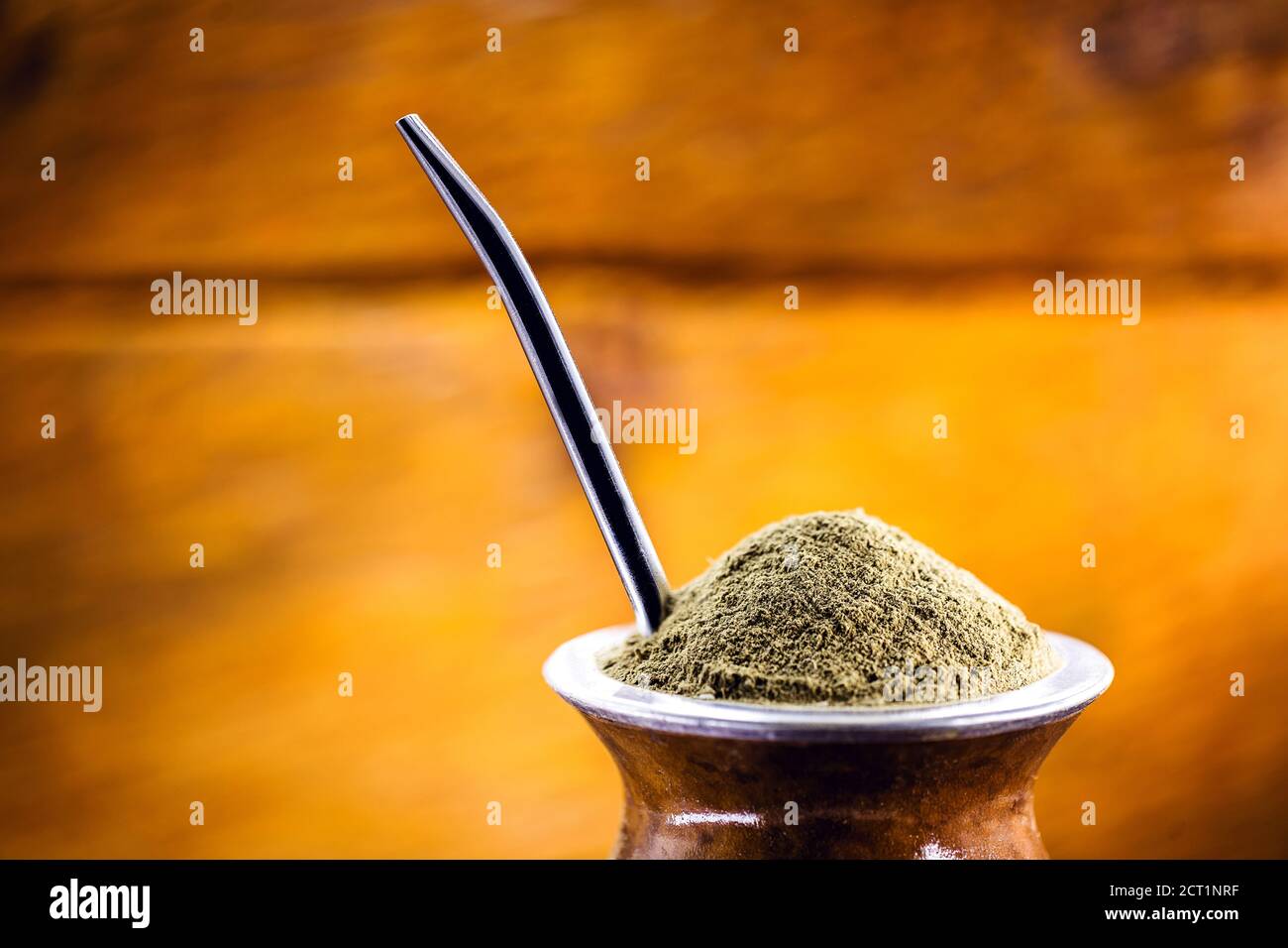 Yerba mate tea in wooden bowl on wooden table. Traditional drink from