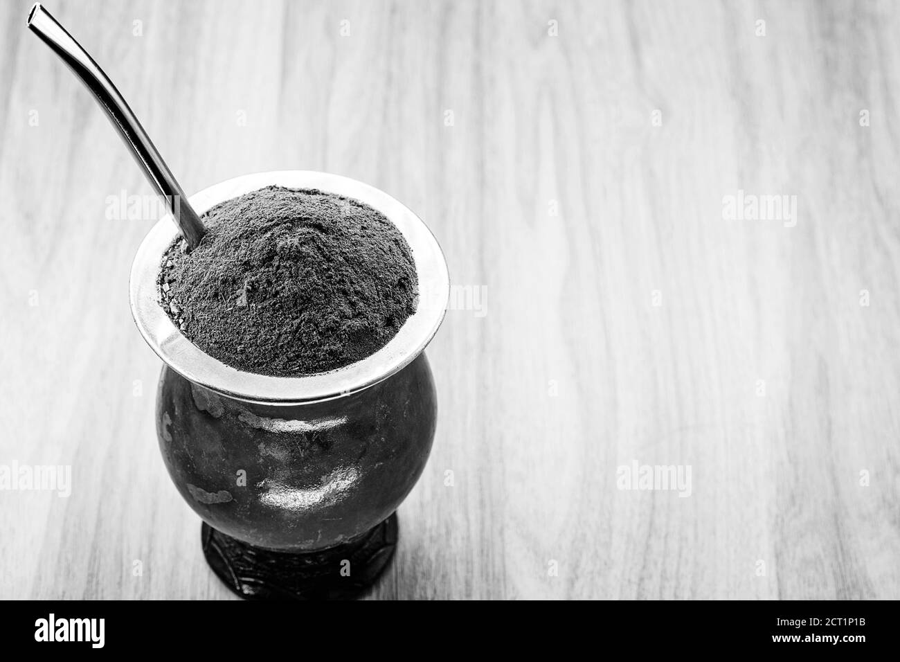 A typical Brazilian drink, o chimarrão, or mate, is a character, Black and white photography, drink in black and white. South American Tradition. Stock Photo