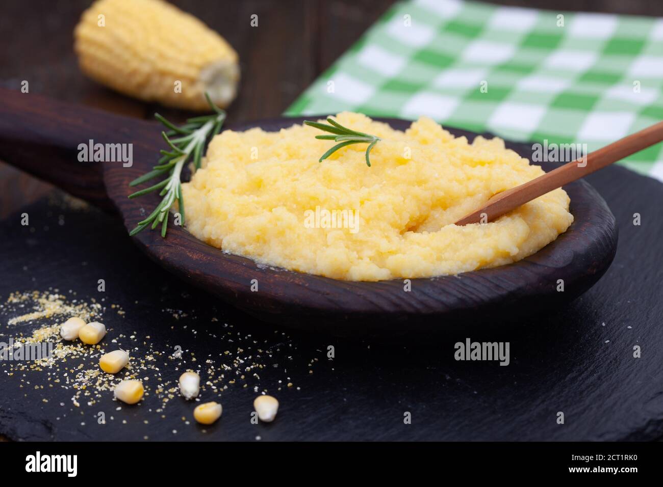 Mamaliga or polenta porridge made out of yellow maize flour. Homemade palenta in wooden bowl, traditional meal on Balkan. Stock Photo