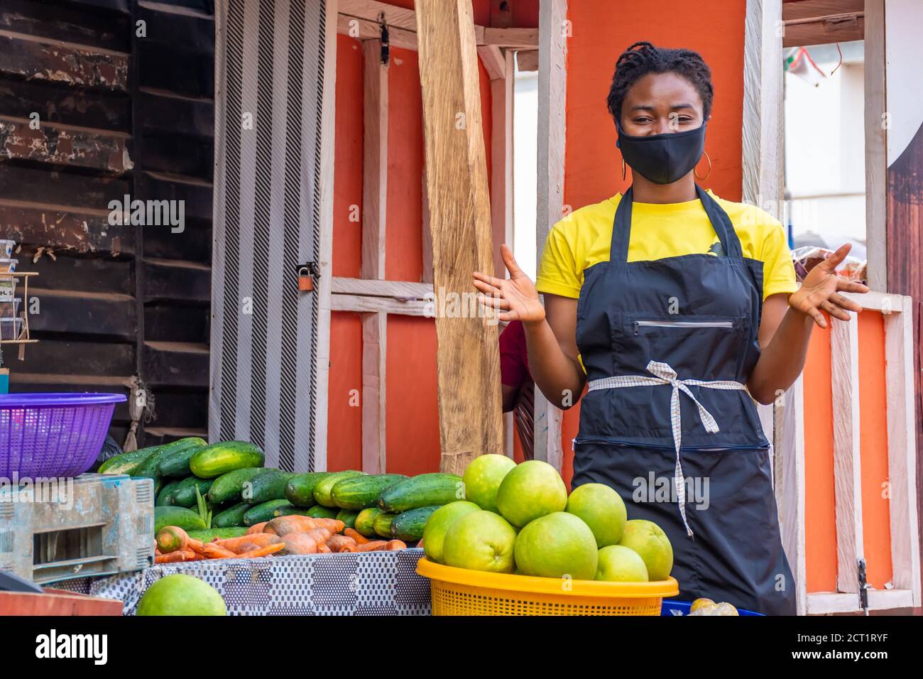 cheerful african market woman wearing a face mask Stock Photo