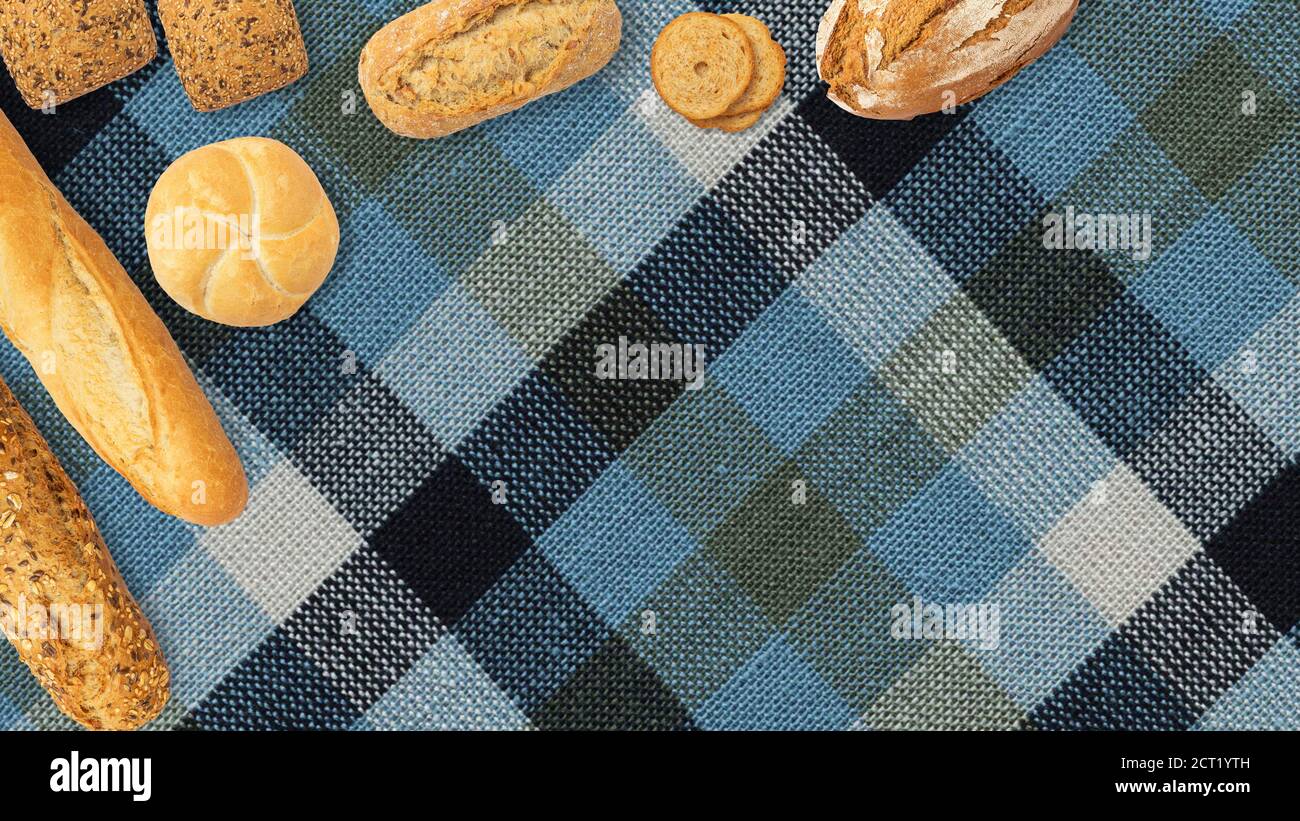 Isolated different kinds of bread on a tablecloth background. Photo of